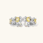 Close-up of platinum-plated copper eternity ring featuring alternating yellow and clear marquise-cut stones in elegant band setting.