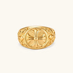 Alternate angle of the 18K gold-plated stainless steel signet ring with ornate cross face and filigree scroll band.