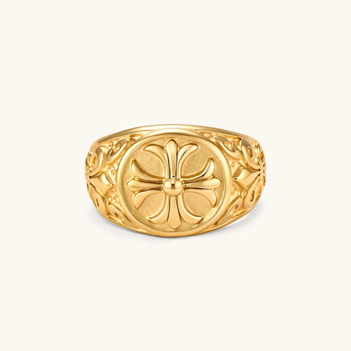 18K gold-plated stainless steel signet ring with ornate cross face and carved filigree scroll band, shown from three angles.