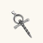 Silver stainless steel ankh pendant with skull motifs on vertical bar and textured ring top, on a box chain necklace.