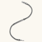 Close-up of the antique silver plated eco-brass foxtail chain bracelet with Greek key engraved bar.