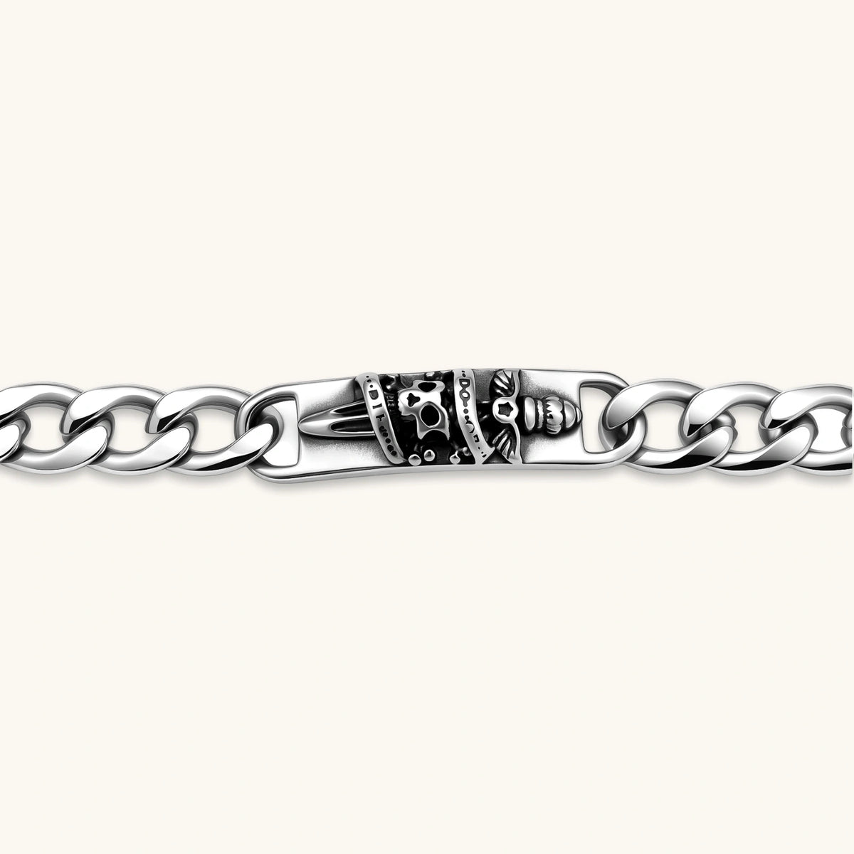 Silver 316L stainless steel Cuban chain bracelet with blackened skull and crown ID bar centerpiece, lobster clasp closure.
