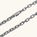 Silver 316L stainless steel rectangular link chain necklace with intricate scroll engravings, 560mm length, 7.1mm width.