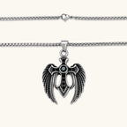 Additional angle of the silver stainless steel angel wing cross pendant with green CZ center stone and black crystals.