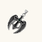 Close-up of the silver stainless steel angel wing cross pendant with green CZ center stone and black crystals.