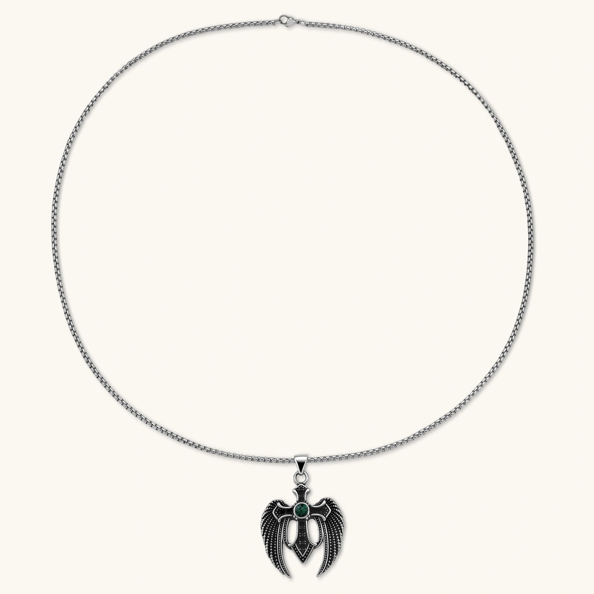 Alternate angle of the silver stainless steel angel wing cross pendant with green CZ center stone and black crystals.