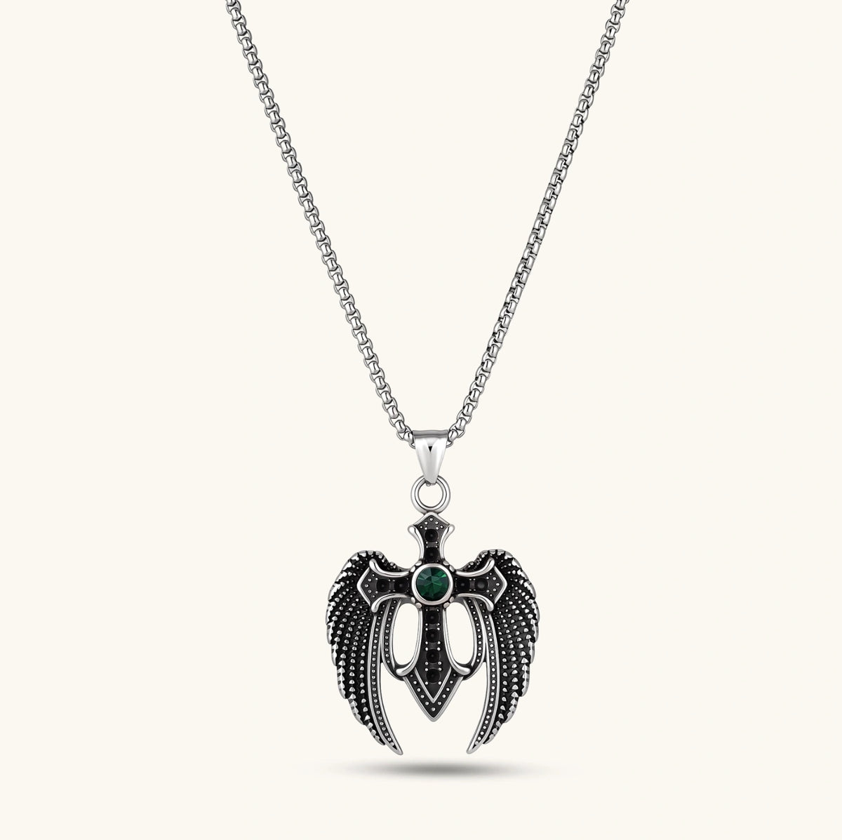 Front view of the silver stainless steel angel wing cross pendant with green CZ center stone and black crystals.