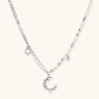 Front view of the silver-toned crescent moon pendant with star accents and a single pearl bead on a fine chain.