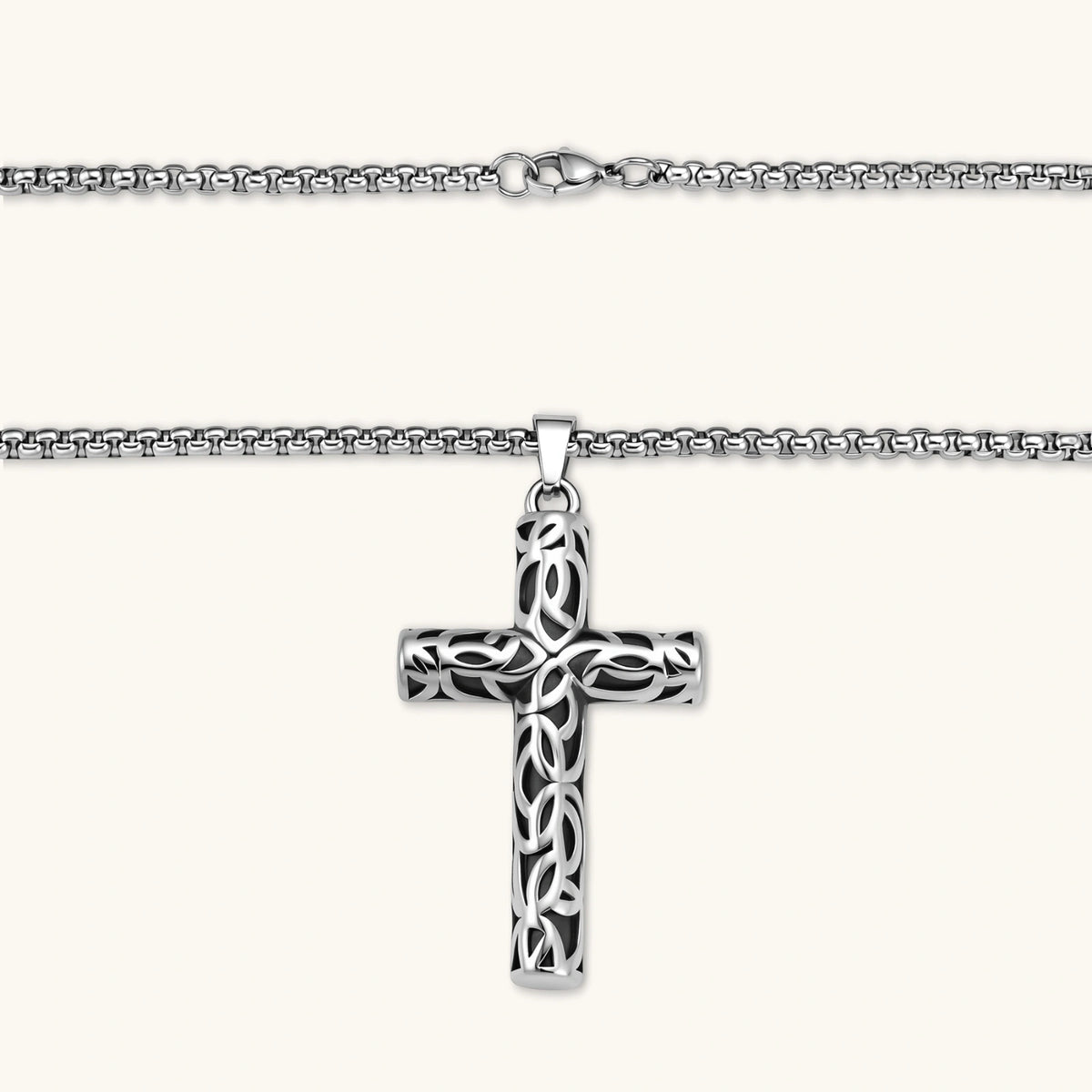 Additional angle of the silver stainless steel Celtic cross pendant with filigree vine pattern on a box chain.