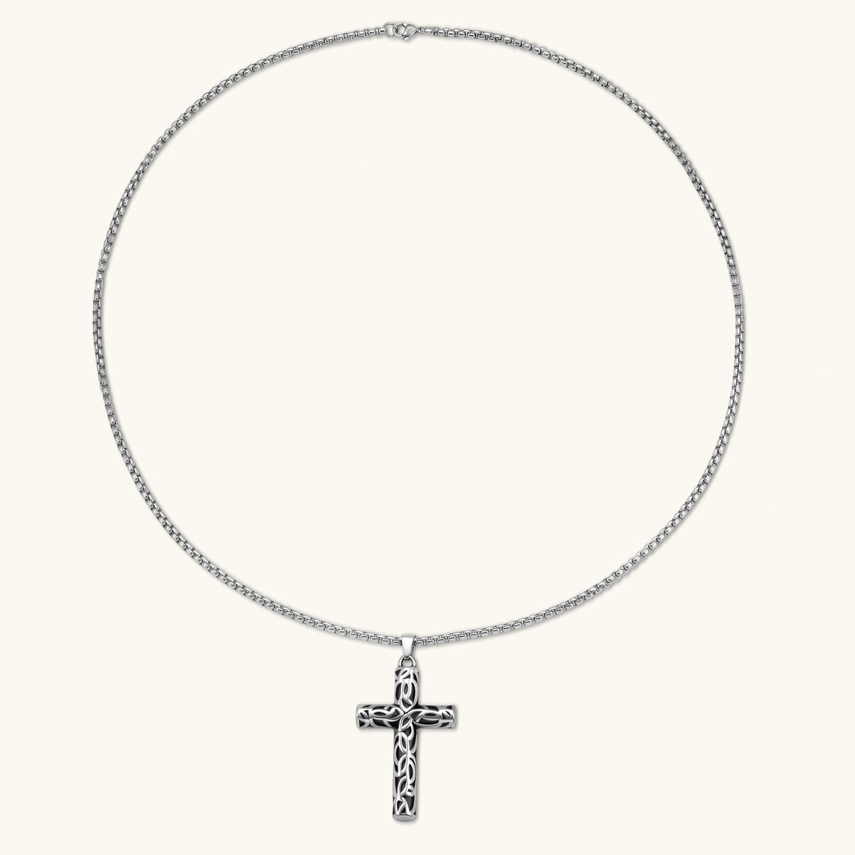 Alternate angle of the silver stainless steel Celtic cross pendant with filigree vine pattern on a box chain.