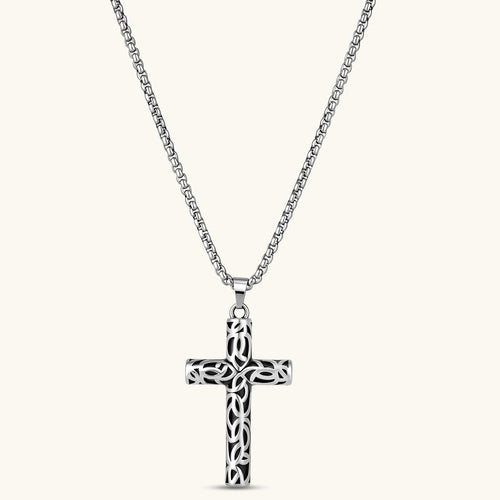 Front view of the silver stainless steel Celtic cross pendant with filigree vine pattern on a box chain.