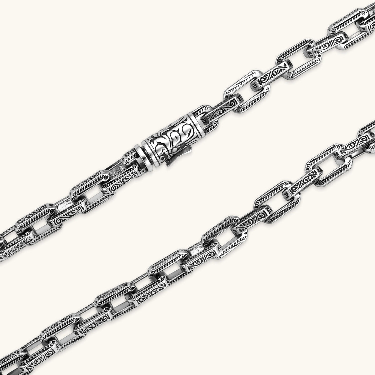 Additional angle of the stainless steel rectangular link chain necklace with scroll engravings.