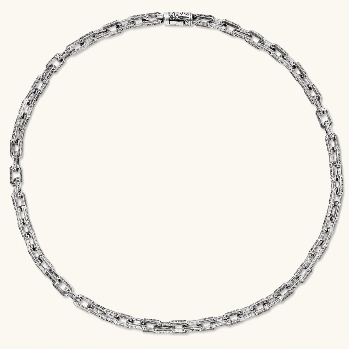 Alternate angle of the stainless steel rectangular link chain necklace with scroll engravings.