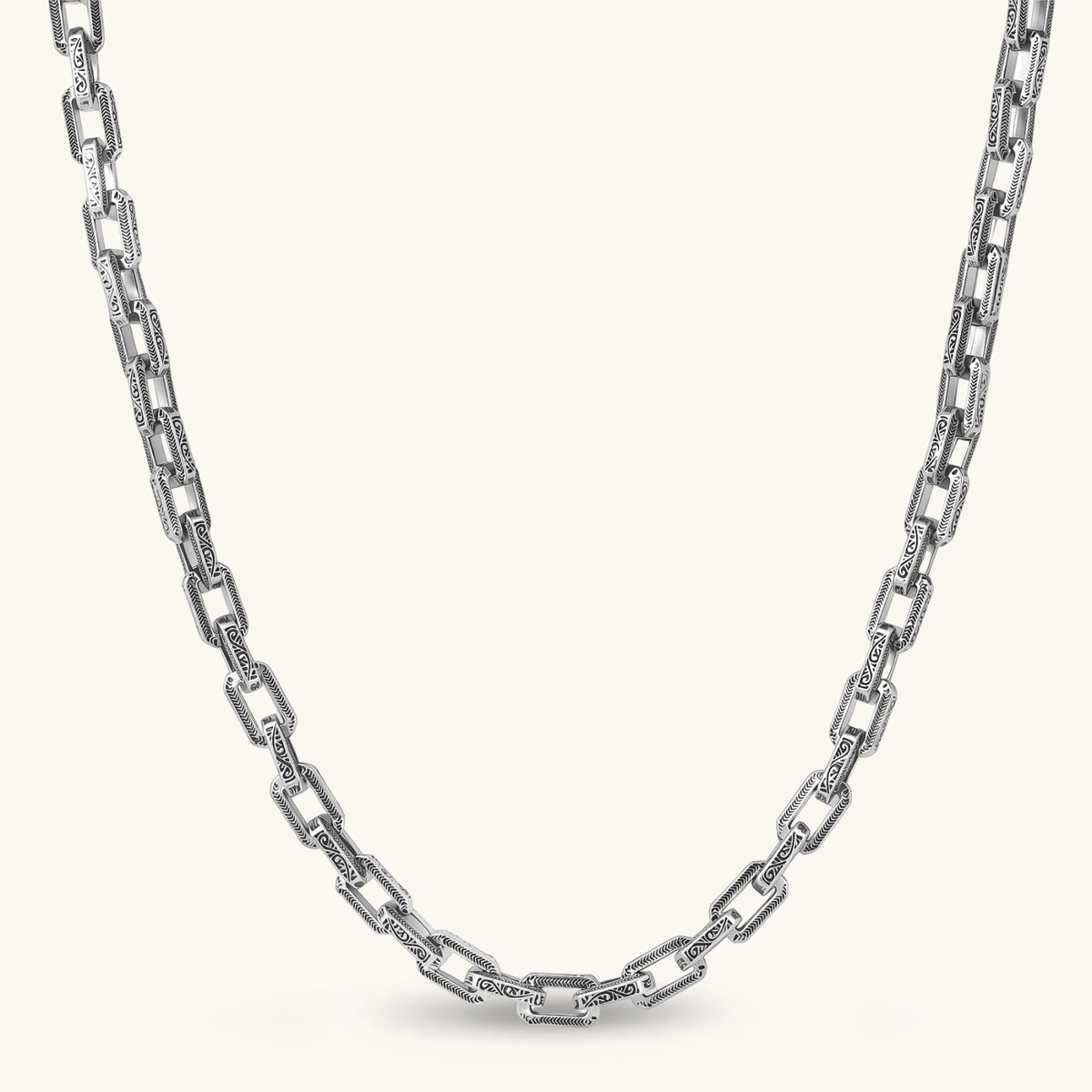 Front view of the stainless steel rectangular link chain necklace with scroll engravings.