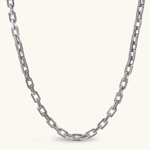 Front view of the stainless steel rectangular link chain necklace with scroll engravings.