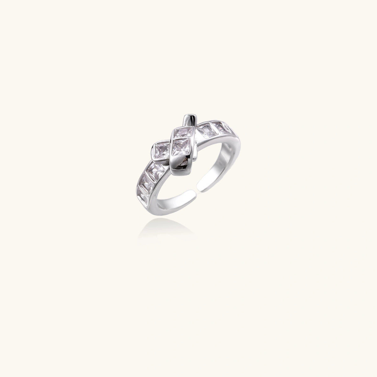 Front view of the white gold-plated adjustable ring with stacked square zirconia stones.