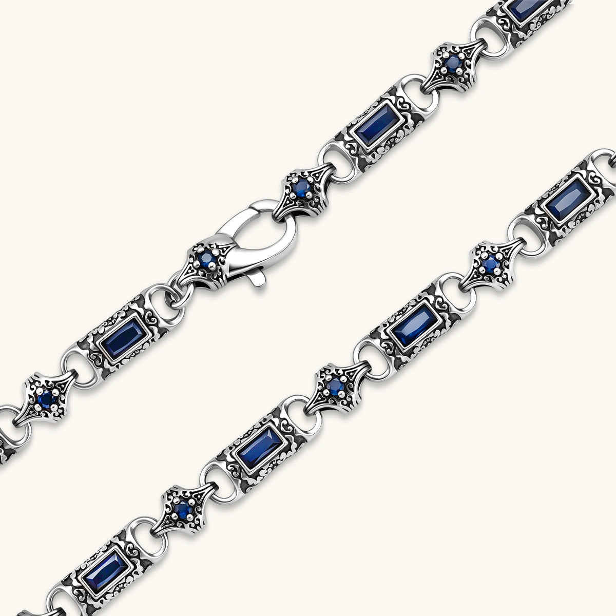 Additional angle of the oxidized silver stainless steel gothic-baroque chain necklace with navy CZ stones.