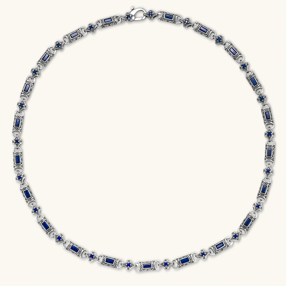Alternate angle of the oxidized silver stainless steel gothic-baroque chain necklace with navy CZ stones.