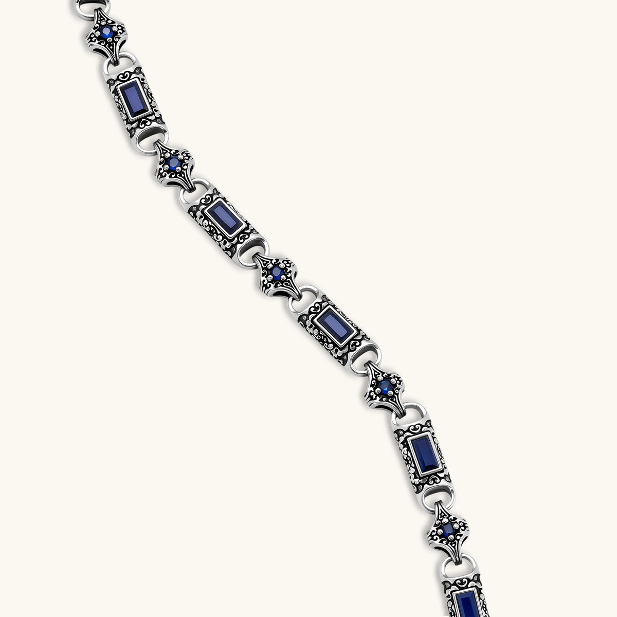 Close-up of the oxidized silver stainless steel gothic-baroque chain necklace with navy CZ stones.