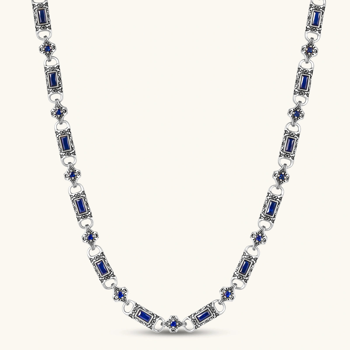 Front view of the oxidized silver stainless steel gothic-baroque chain necklace with navy CZ stones.