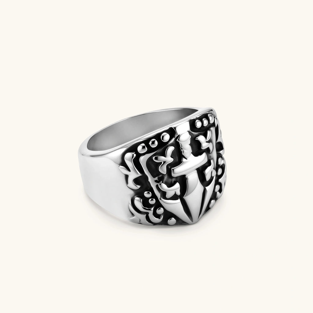 Alternate angle of the stainless steel signet ring with raised knight shield and cross motif.