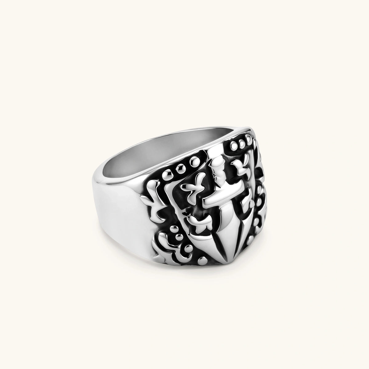 Alternate angle of the stainless steel signet ring with raised knight shield and cross motif.
