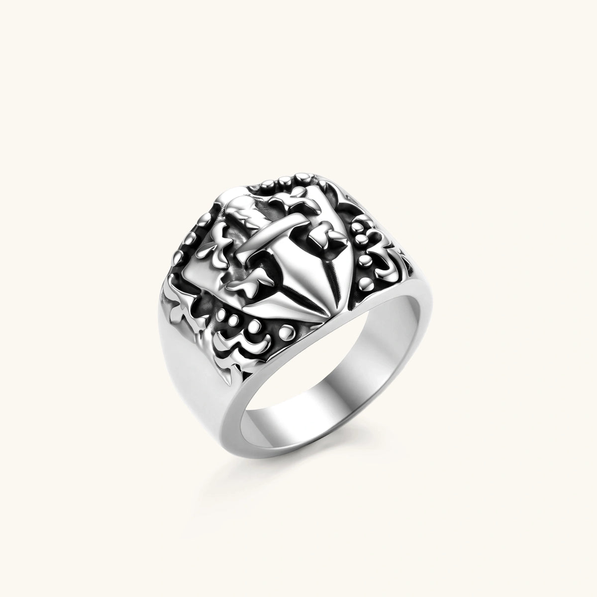 Front view of the stainless steel signet ring with raised knight shield and cross motif.