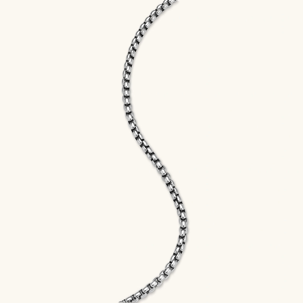 Additional angle of the stainless steel ankh pendant with skull motifs on a box chain necklace.