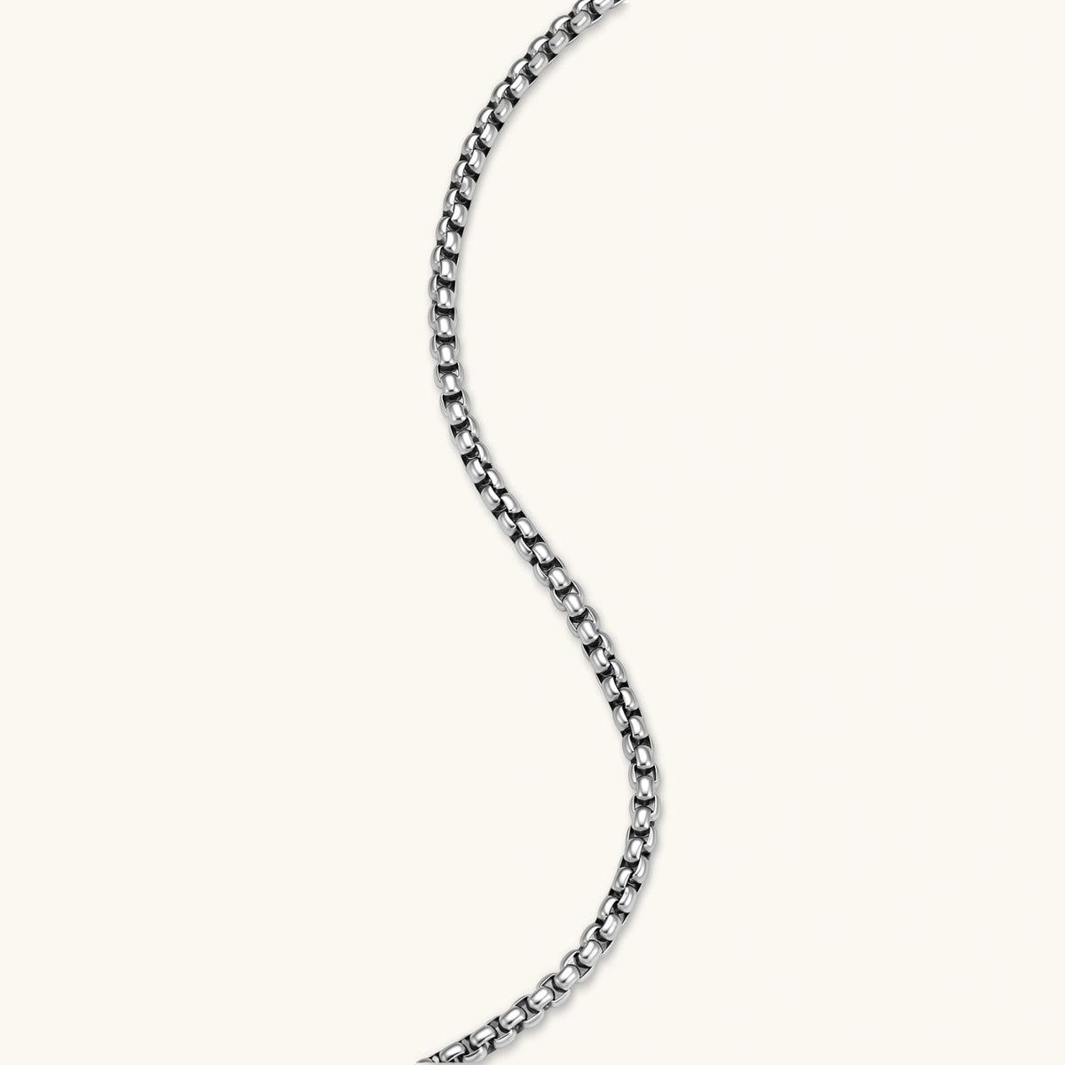 Additional angle of the stainless steel ankh pendant with skull motifs on a box chain necklace.