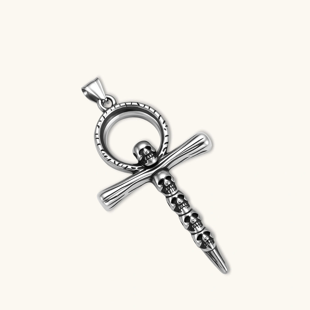 Close-up of the stainless steel ankh pendant with skull motifs on a box chain necklace.